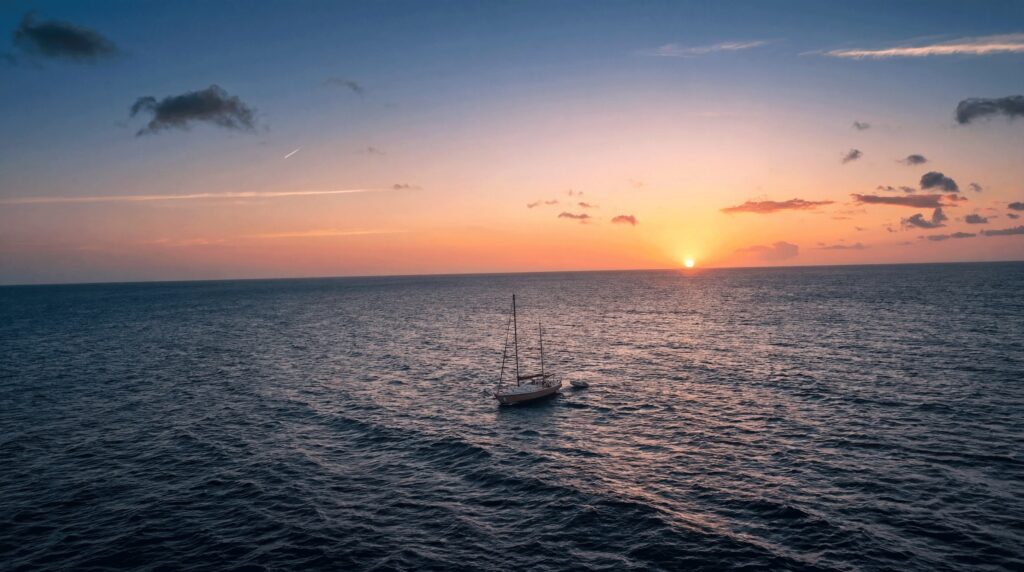 Coucher de soleil sur la mer avec le voilier au mouillage, Curaçao